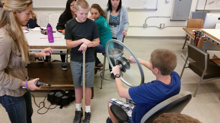Students playing with flywheel
